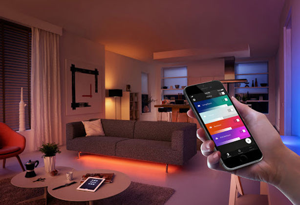Smart home lighting controlled by smartphone in modern living room – NeuroWerx home automation services.